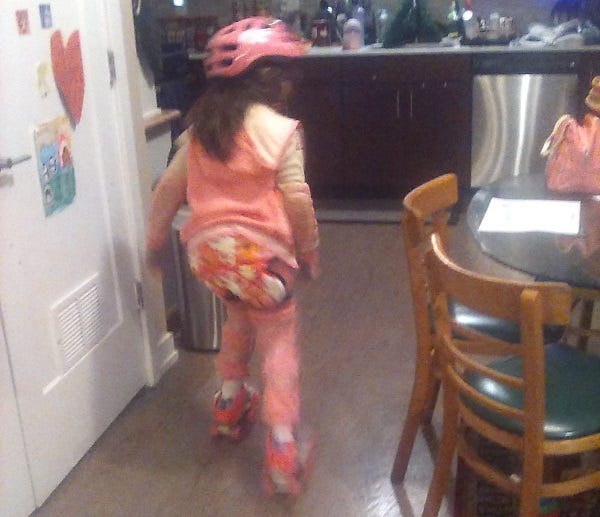 A young girl preparing for roller skating practice