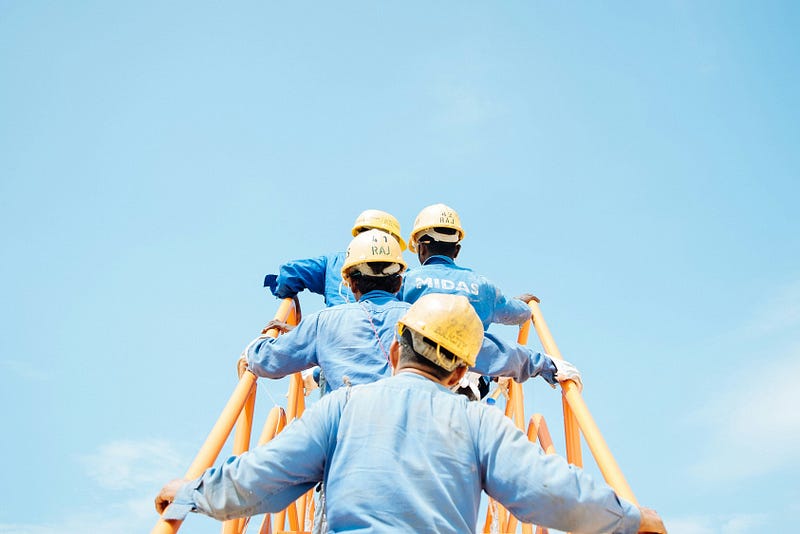 Workers waiting for meals in the sun