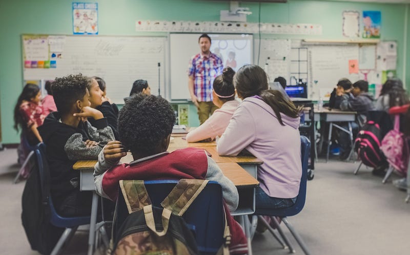 Teacher engaging with students in a classroom setting